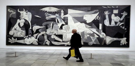 epa05886093 A visitor looks at the artwork 'Guernica' by Spanish artist Pablo Picasso during the presentation of the exhibition 'Pity and Terror. Picasso's Path to Guernica' at the Reina Sofia Museum in Madrid, Spain, 03 April 2017. The show runs from 05 April to 04 September.  EPA/CHEMA MOYA