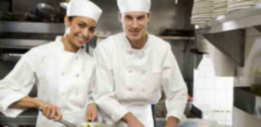 Male and female chefs in restaurant kitchen
